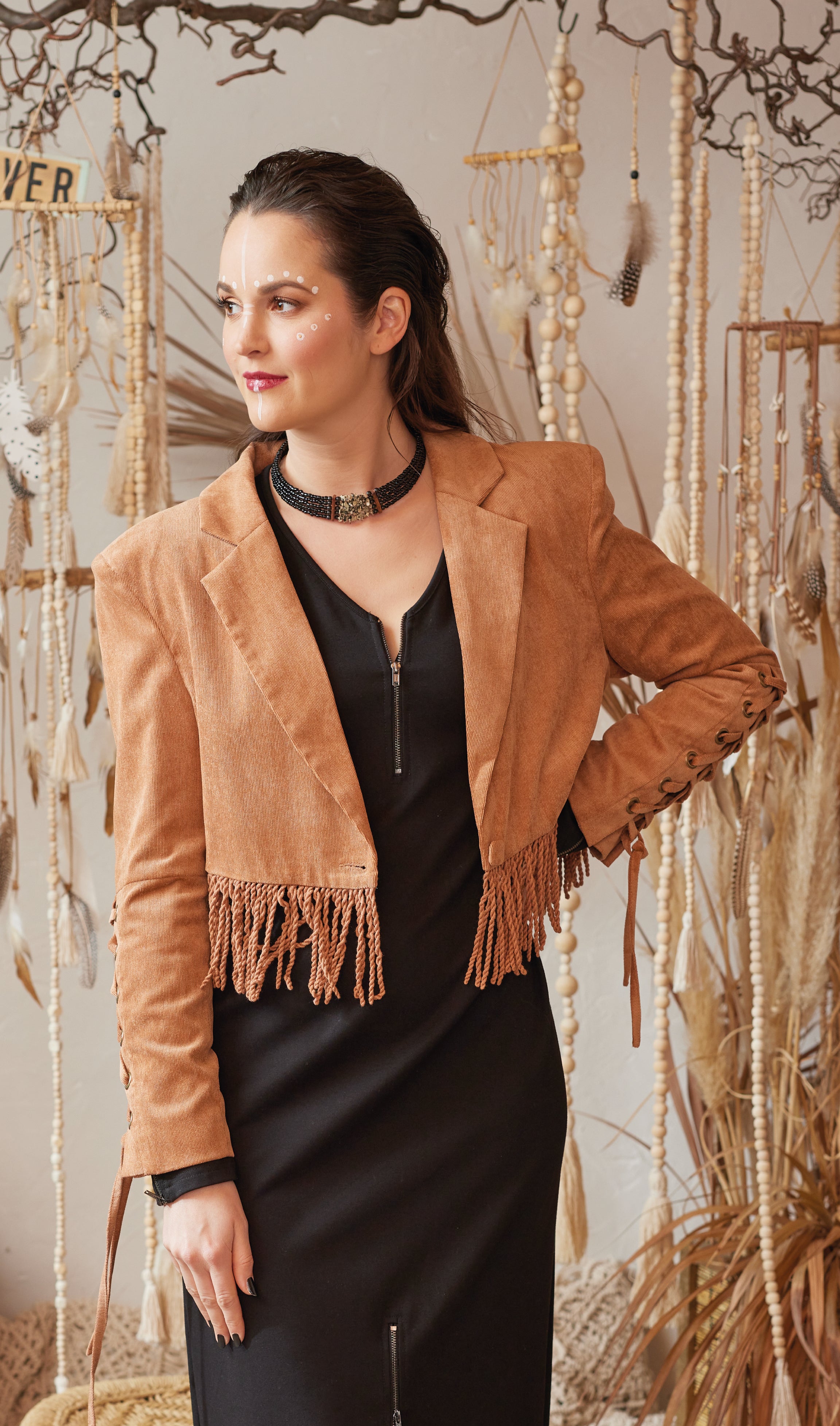 Entdecke die limitierte Boho Fransen Feincord Jacke in wunderschönem Karamell Farbton! Der weiche und bequeme Feincord Stoff, der moderne kastige Schnitt und der stylische Animal-Print im Innenmaterial machen diese Jacke zu einem absoluten Must-Have. Mit Reverskragen, Schulterpolstern und hochwertig mit Feincord überzogenem Knopf. Perfekt abgerundet durch Schnürung und Nieten-Detail an den Ärmeln.