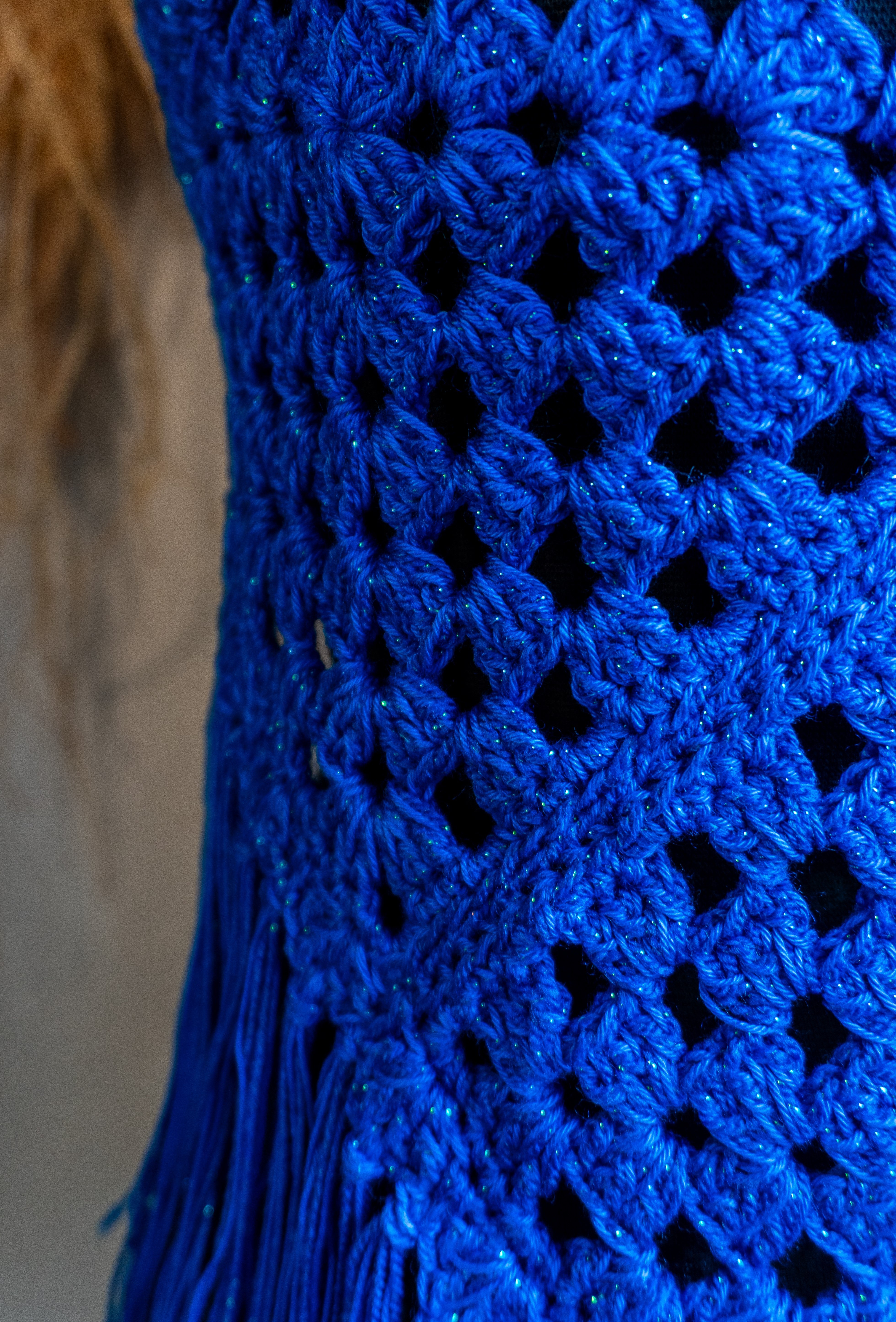 Das handgefertigte Häkeltop in strahlendem Königsblau mit Metallic-Effekt Garn und Fransen ist der ideale Begleiter für Festivals, Strandtage und den Sommer! Die verstellbaren Bänder am Nacken und Rücken sorgen für bequemen Tragekomfort. Die Verwendung von hochwertiger merzerisierter Baumwolle verleiht dem Top eine besonders weiche Textur.