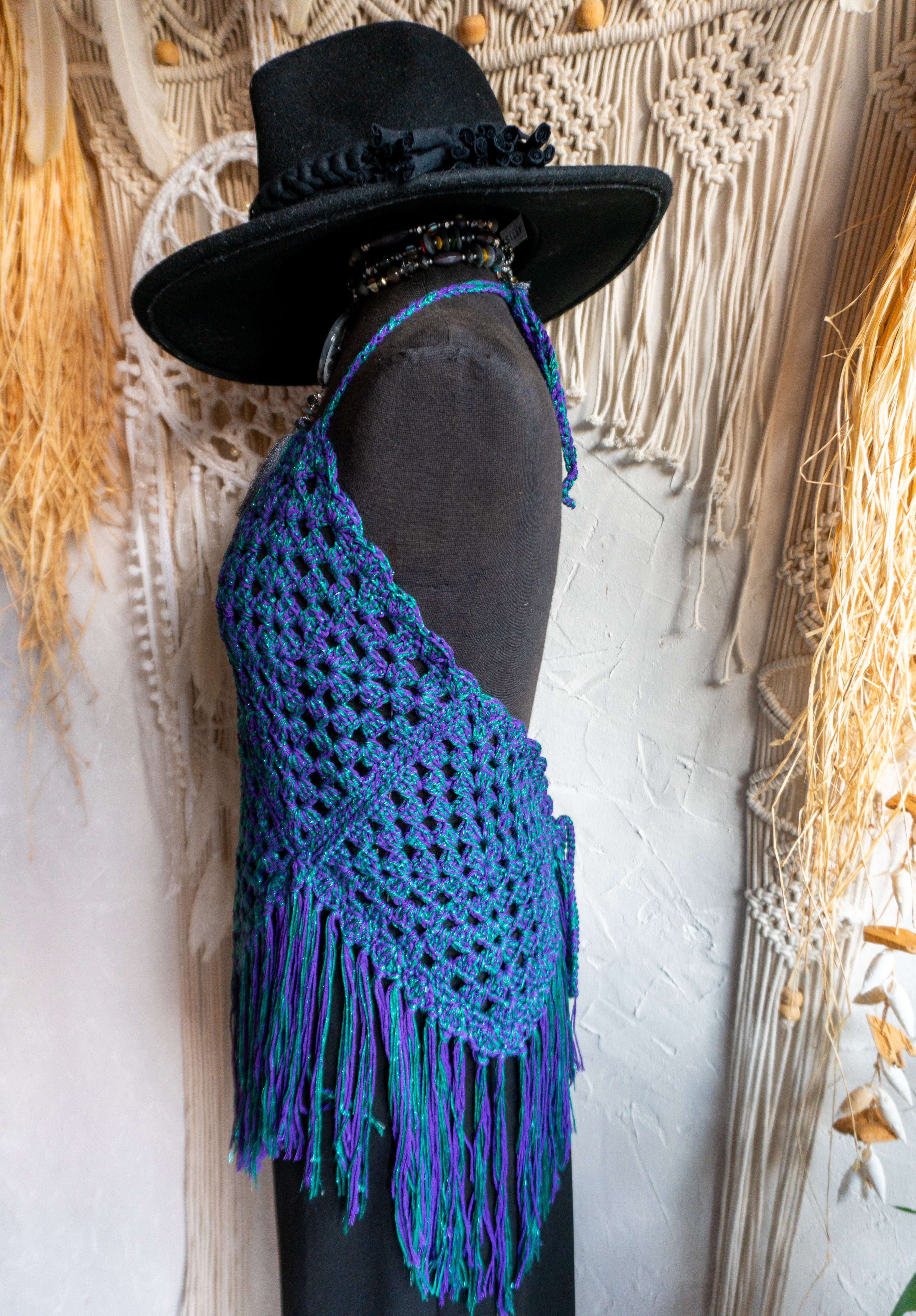 Handgefertigtes Unikat Häkeltop in einem auffälligen Farbmix aus Lila-Grün Metallic - ein stylisher Hingucker! Perfekt für ein stylisches Boho-inspiriertes Outfit. Individuell anpassbare Neckholder-Träger und Rückenbänder sorgen für perfekten Sitz und ein angenehmes Hautgefühl. Die stylischen Fransen verleihen dem Top eine lässige Note und machen es zum absoluten Must-have. Kombiniere es nach Bedarf mit einem passenden Bikini Oberteil darunter. Mit Liebe in Deutschland handgefertigt.