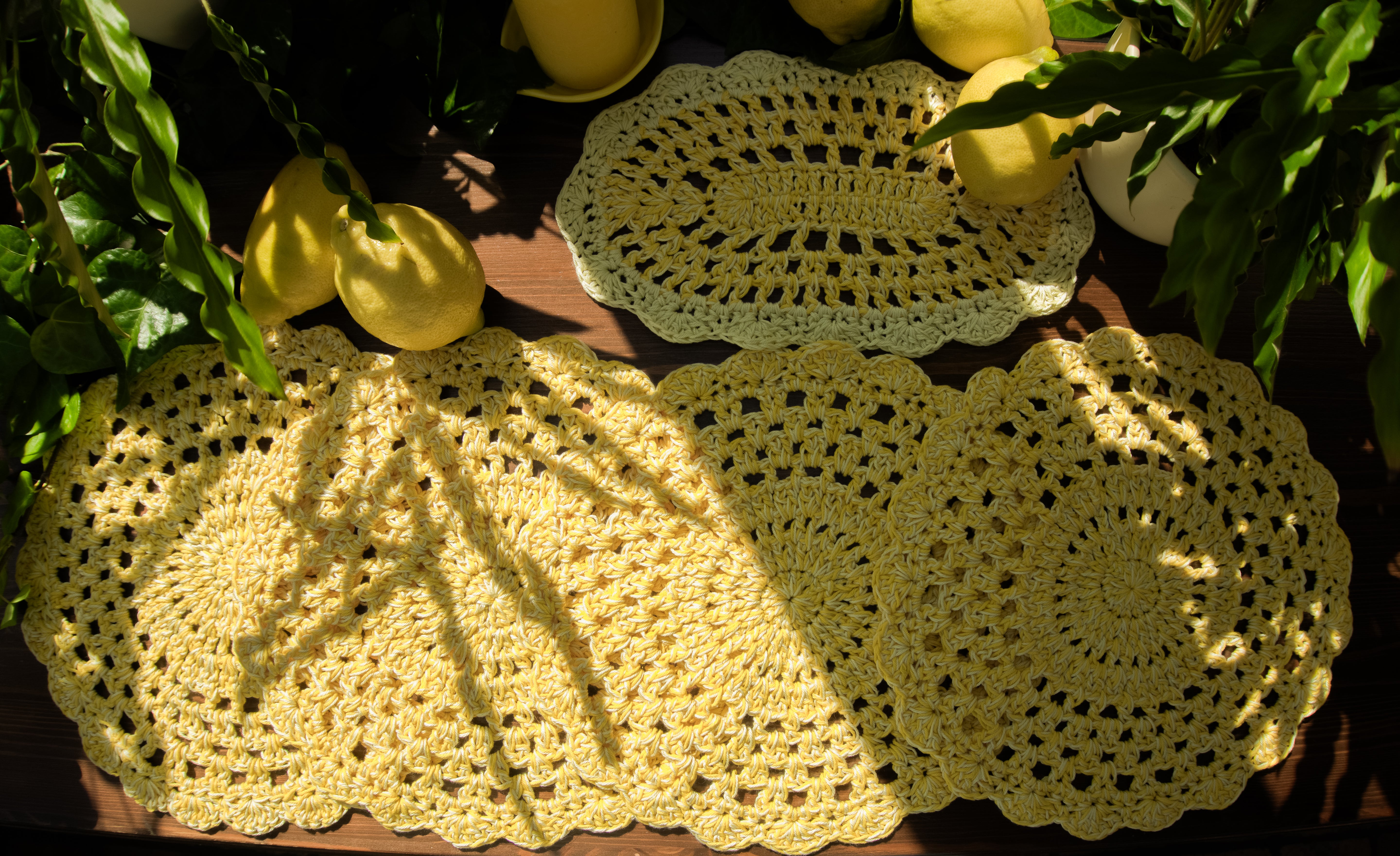 Fünfteiliges Häkel Tischset in trendigem Zitronengelb. Handgefertigt und vielseitig einsetzbar, als Ergänzung für moderne Zitronendekoration oder als Untersetzer für ein Blumenvase und Kerzenständer. Unikat-Set mit vier runden Tischsets und ein kleines ovales Deko-Deckchen.